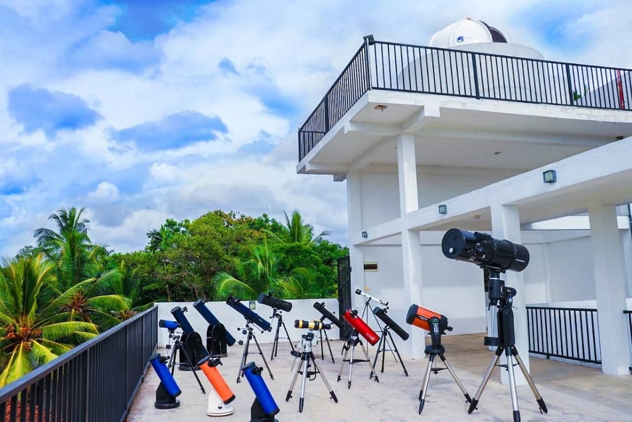 Observatory terrace with several telescopes beneath a dome